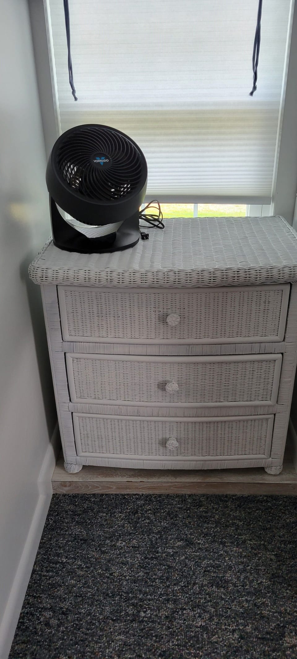 Bureau in bunk bedroom next to full size stacked washer & dryer.