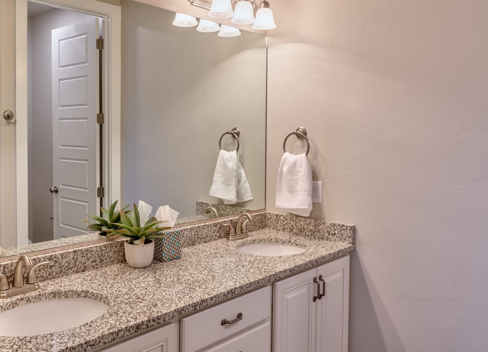 Main Bathroom View - The Main Bathroom includes his and her sinks, toilet, vanity and walk-in shower.