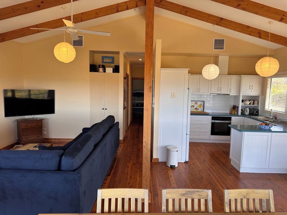 Looking from dining area towards kitchen & lounge/TV/music/Internet area