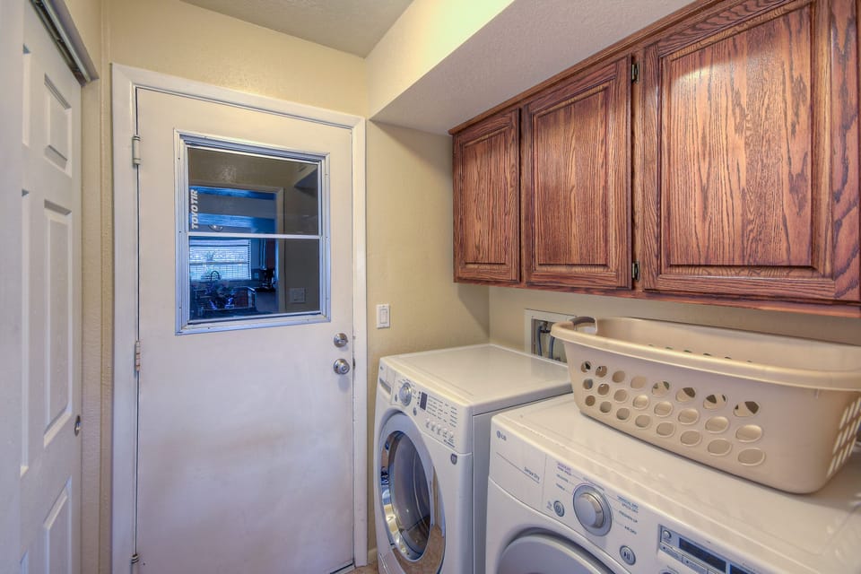 Laundry room has family size, front loading appliances and is stocked with detergent.