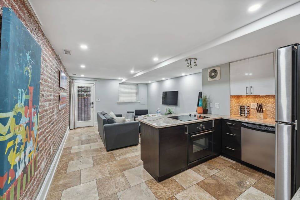 Open-concept kitchen and family room with exposed brick and modern touches.