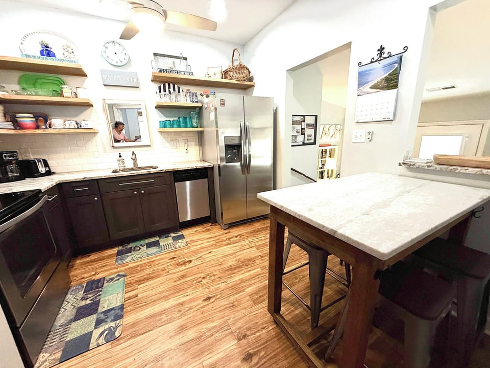 Pass-though window between kitchen and living.  Island on wheels for eating together or for use as counter space for preparing meals.