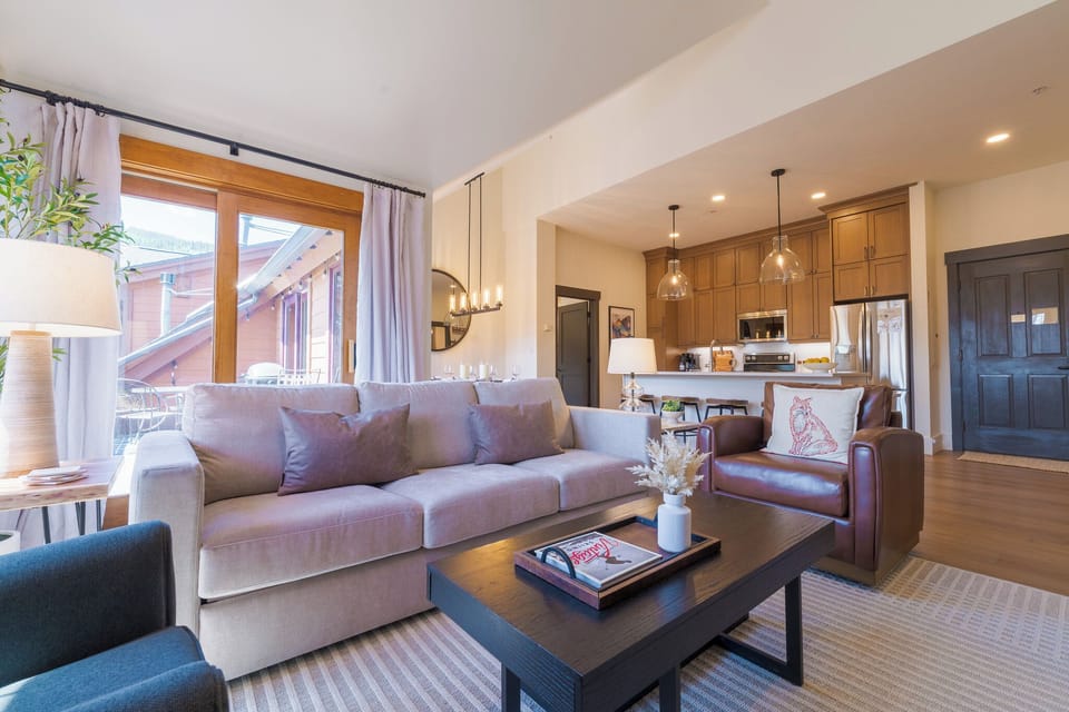 Open living area with a Room & Board king sleeper sofa and kitchen views.