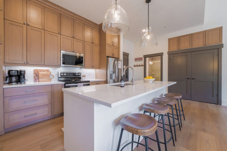 Oversized kitchen island with seating, and generous prep space and sink.