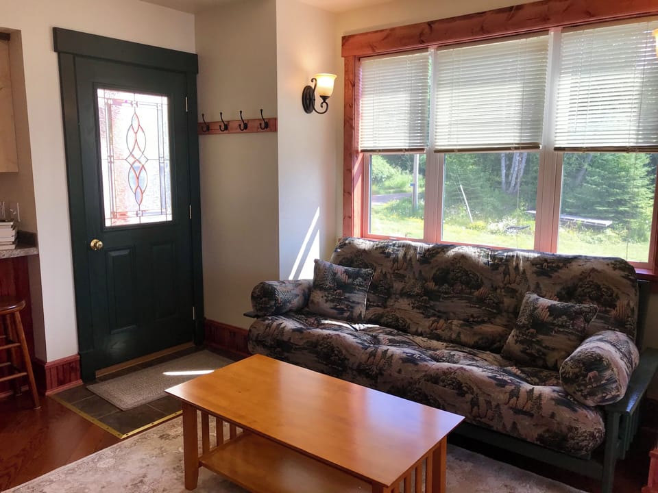 Entry and Futon
Take a family trip to recharge. This living space enjoys a futon that folds into a full-sized bed providing enough sleeping space for your kids while you retreat to the bedroom upstairs.