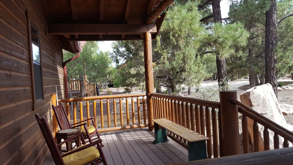 Front porch with 2 rocking chairs and a bench.