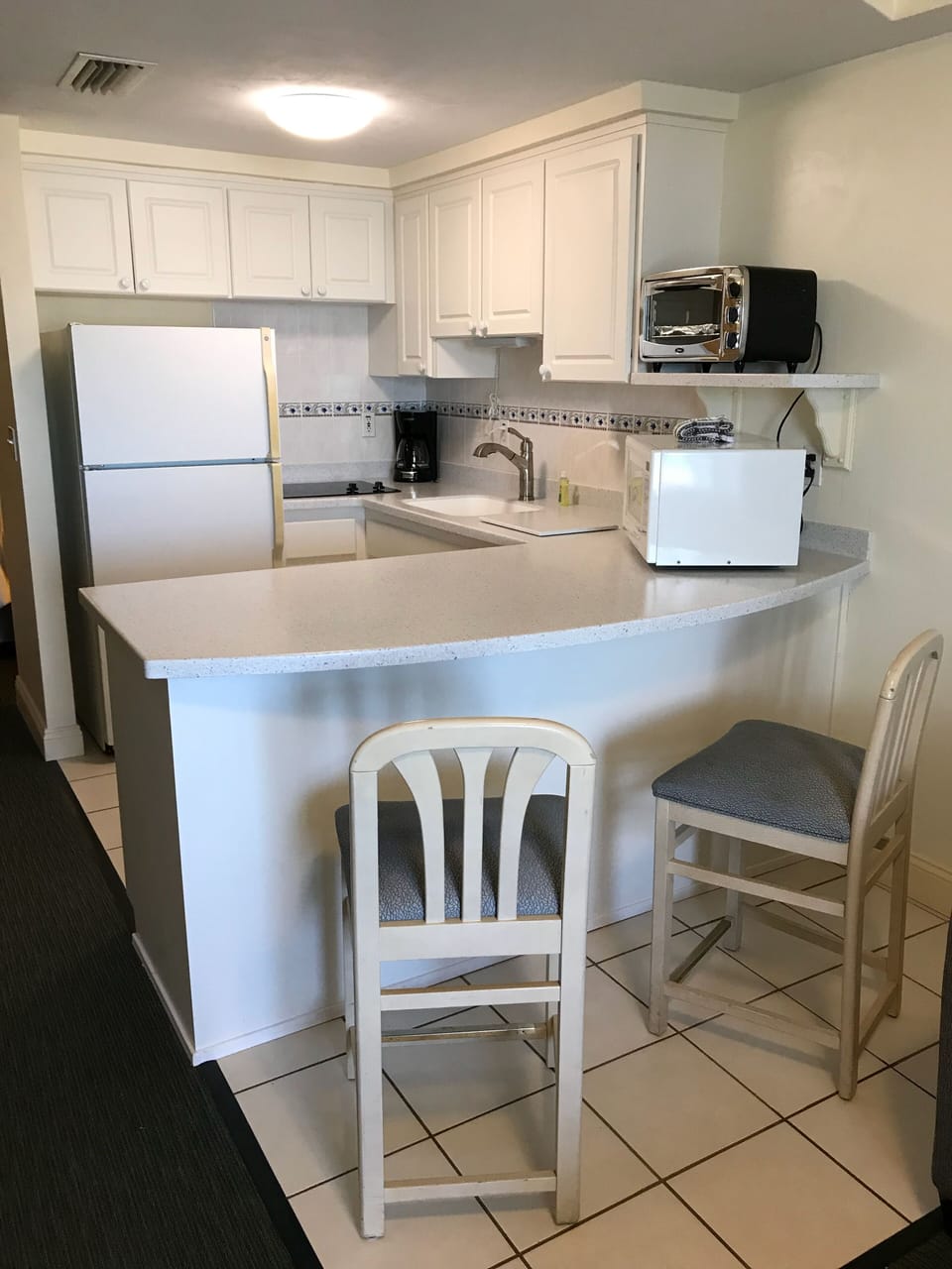 Kitchen with new counter and two stove top burners 