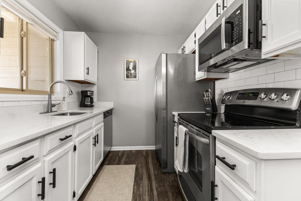 Fully Equipped Kitchen - White shaker-style cabinetry, Dark hardware, and White subway tile backsplash