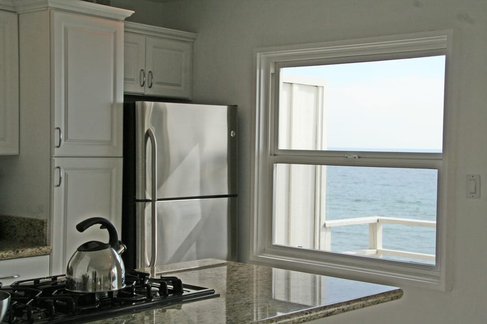 Granite counters & stainless steel appliances with panoramic ocean views