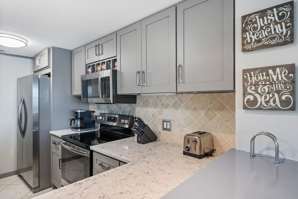 Updated kitchen with stainless steel appliances.
