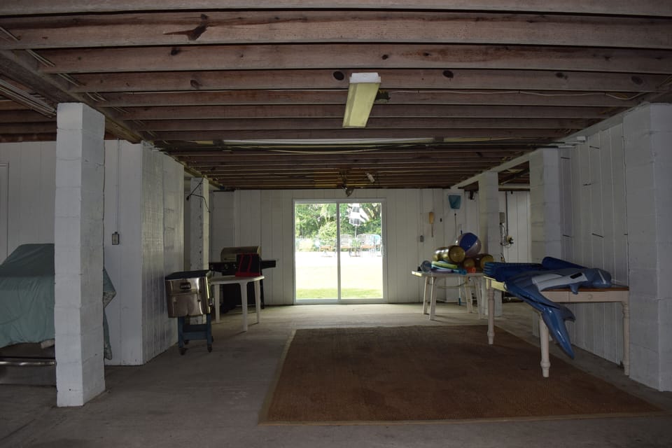 Under house space leading to backyard in-ground pool