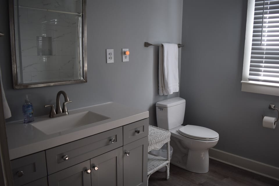 Bathroom sink, vanity, and toilet