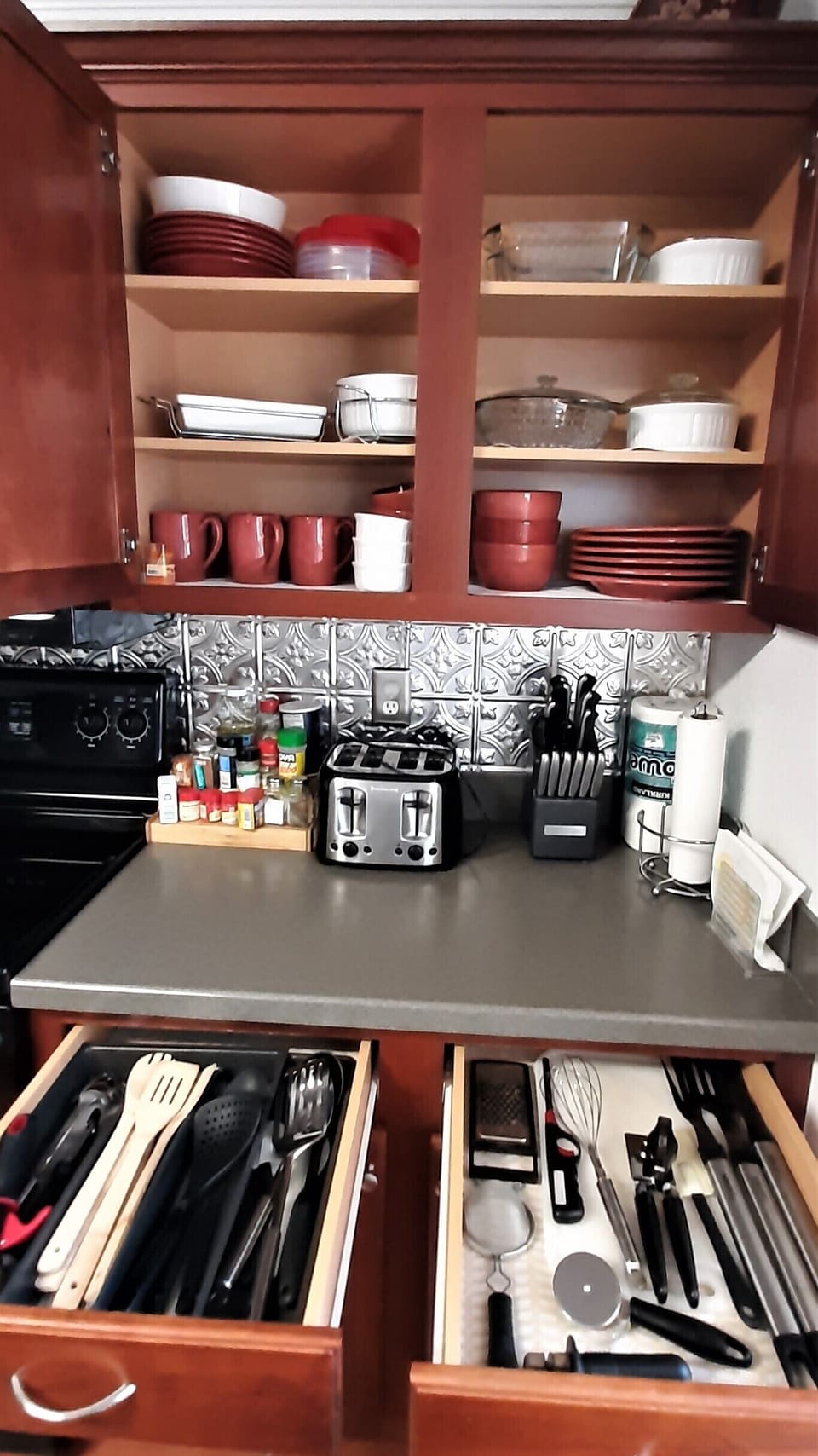 Cooking utensils, knives, bbq tools, toaster, condiments. 