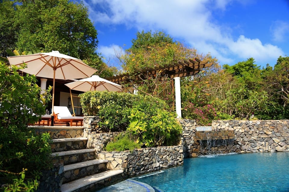 Cascading salt water pools set within a tropical garden paradise are literally steps away from the main living area.