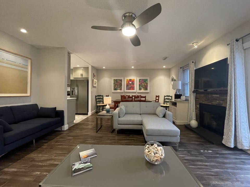 Open living room with space to relax, watch TV, and read after the beach.  