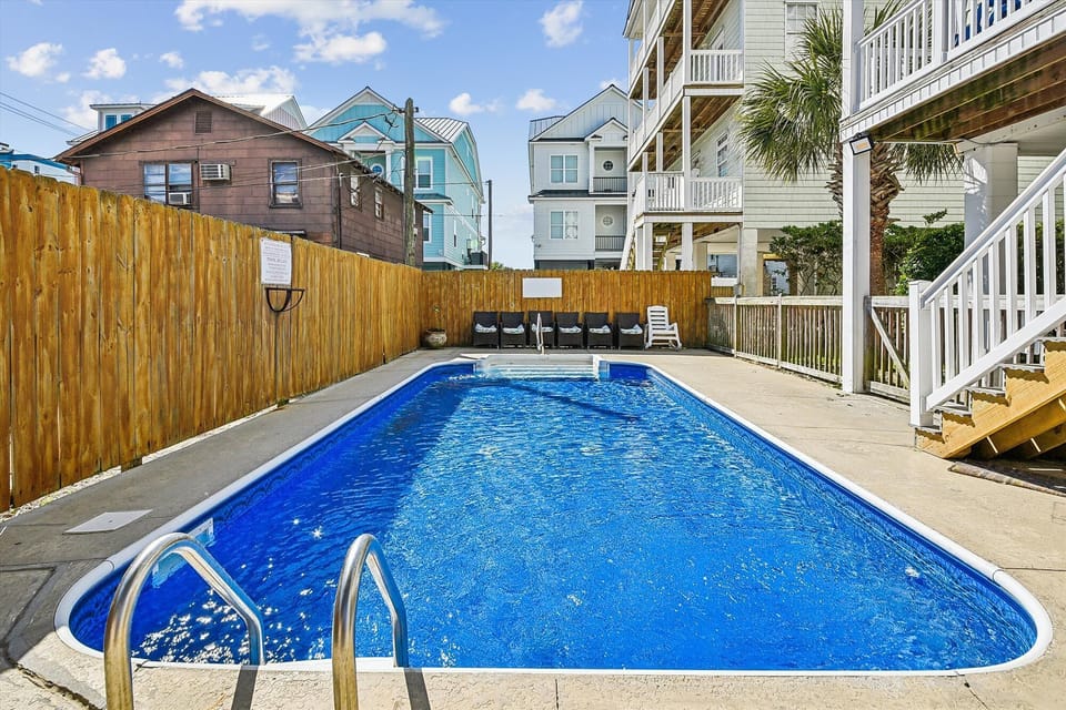 Take a cool dip in the sparkling pool after a fun day at the beach.