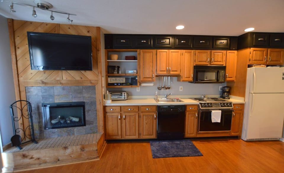 Kitchen area with gas fireplace.