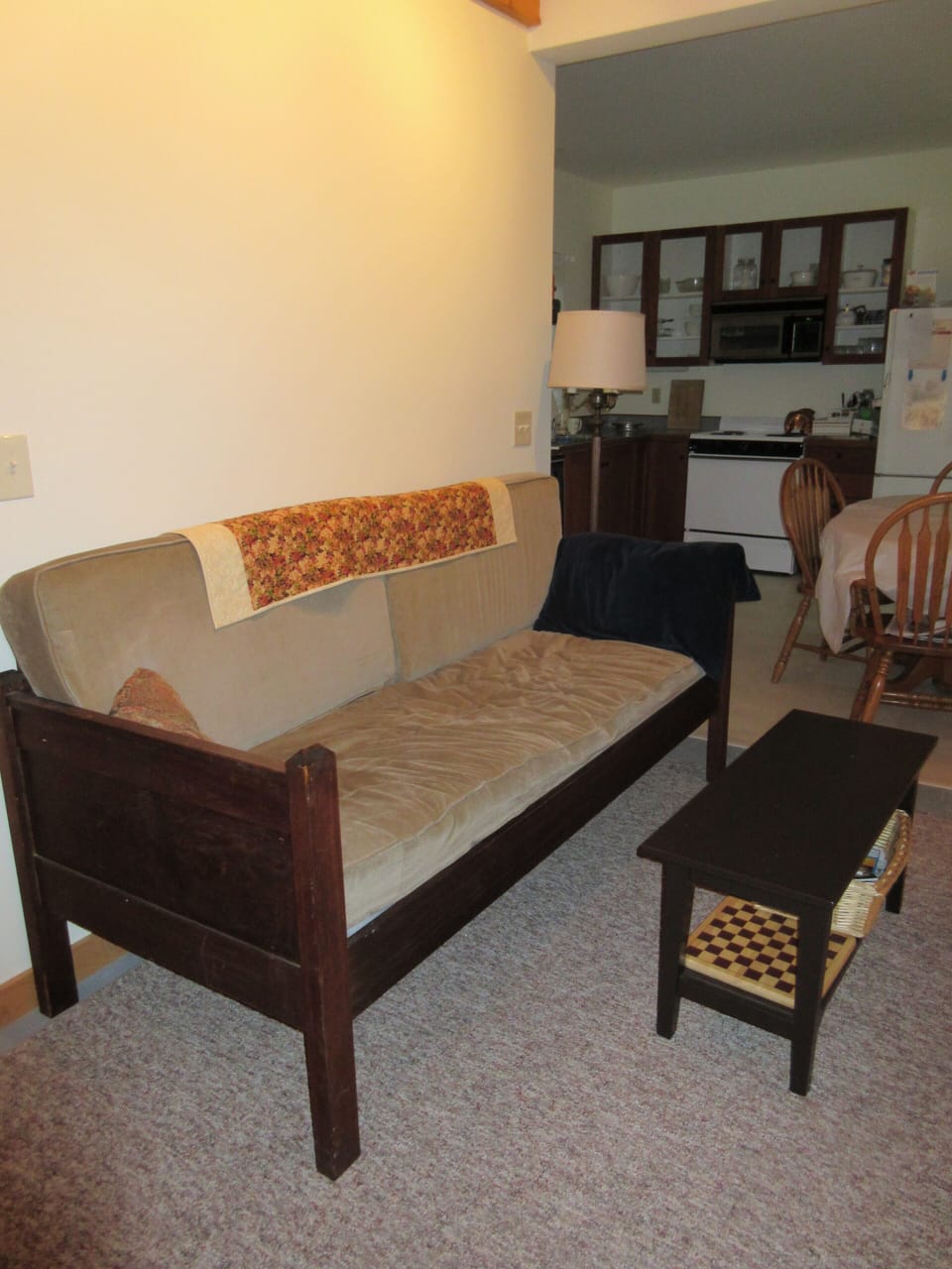 Living room showing couch and kitchen beyond