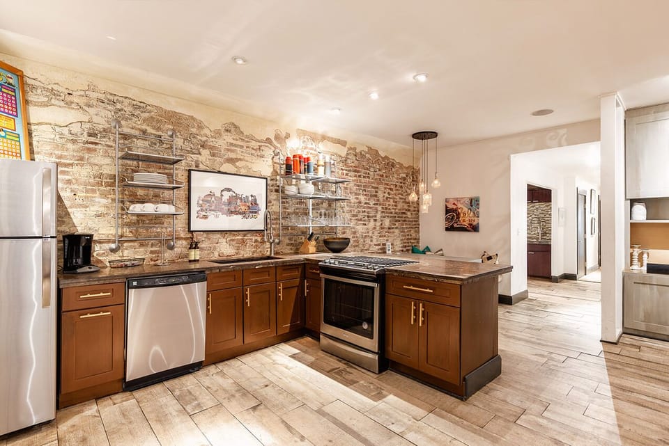 Stainless Steel Kitchen Flows Into Second Living Room