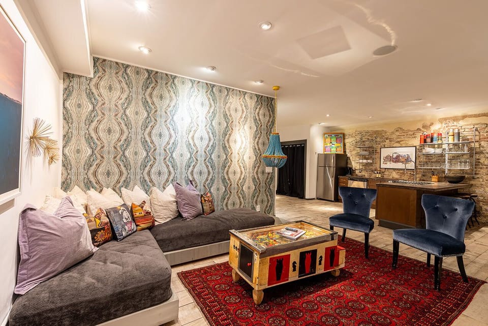 Second Living Area with Large TV and Sectional That Splits into Twin Beds