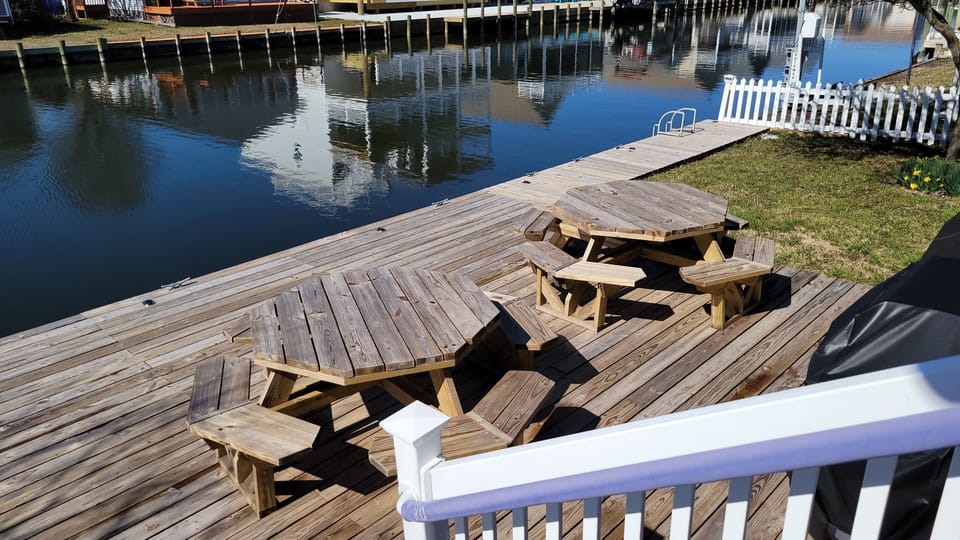 Crab and fish from the bayside dock with two picnic tables and cleats for a boat
