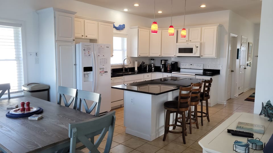 Fully stocked kitchen with breakfast bar, keurig and 12 cup coffee maker.