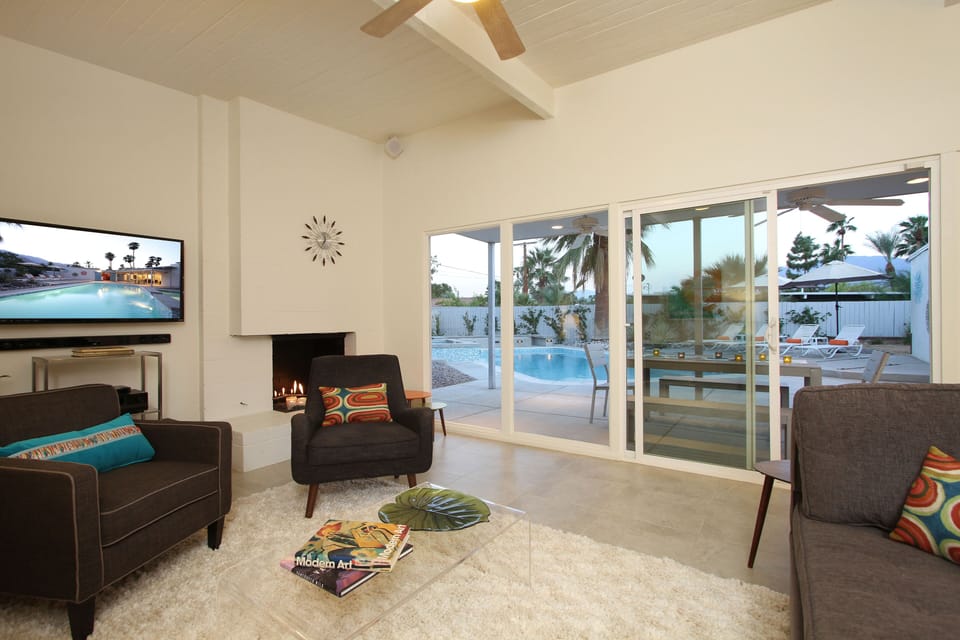 Living room features HDTV and indoor/outdoor sound system. Fireglass fireplace.