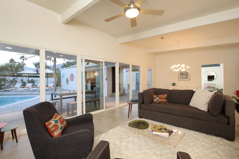 View of living room with view out to resort-like back garden.