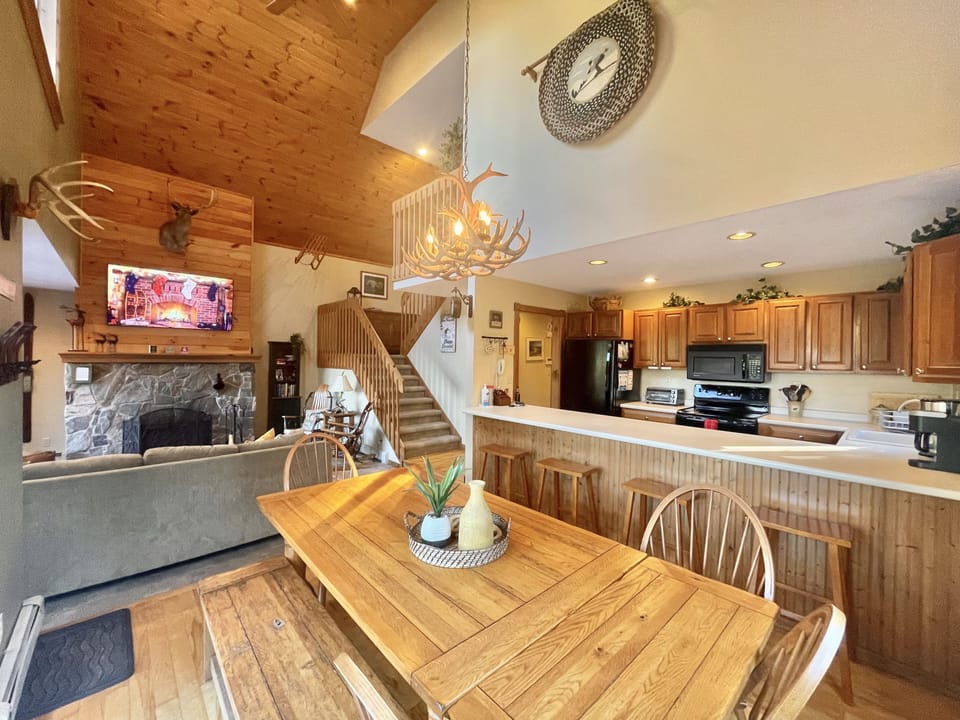 Dining Room and Kitchen are Open and Sits up to 12. Stairs lead up to top floor.