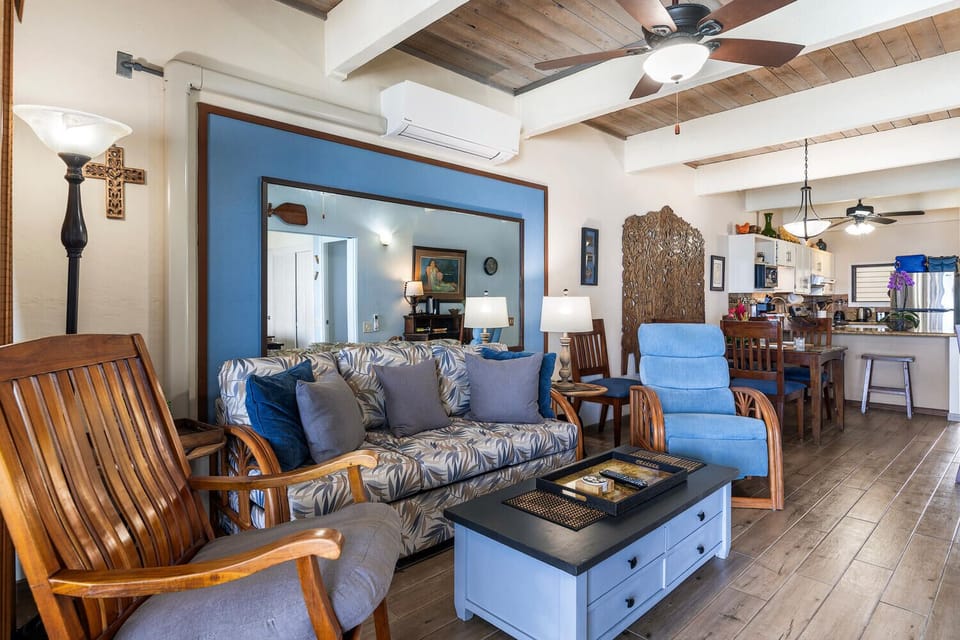 Wood-grain tile floors keep the unit cool; the open beam ceilings feel spacious.