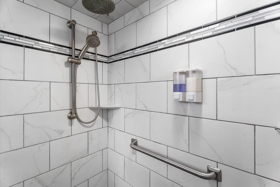 Master bath: walk-in shower, rain shower head & hand-held shower head, grab bar.