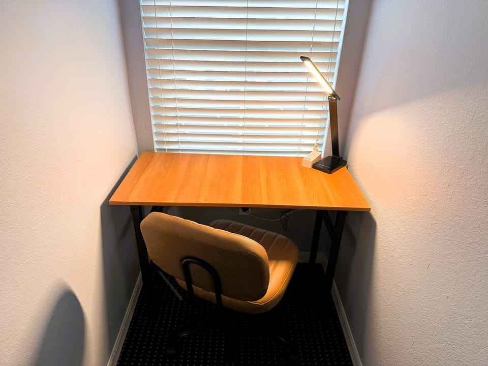 Work area with lamp and power strip in loft.