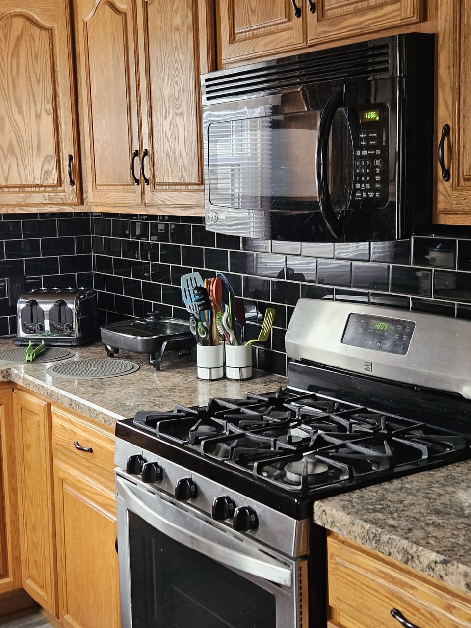 Kitchen area with micro wave, gas stove, electric skillet and toaster