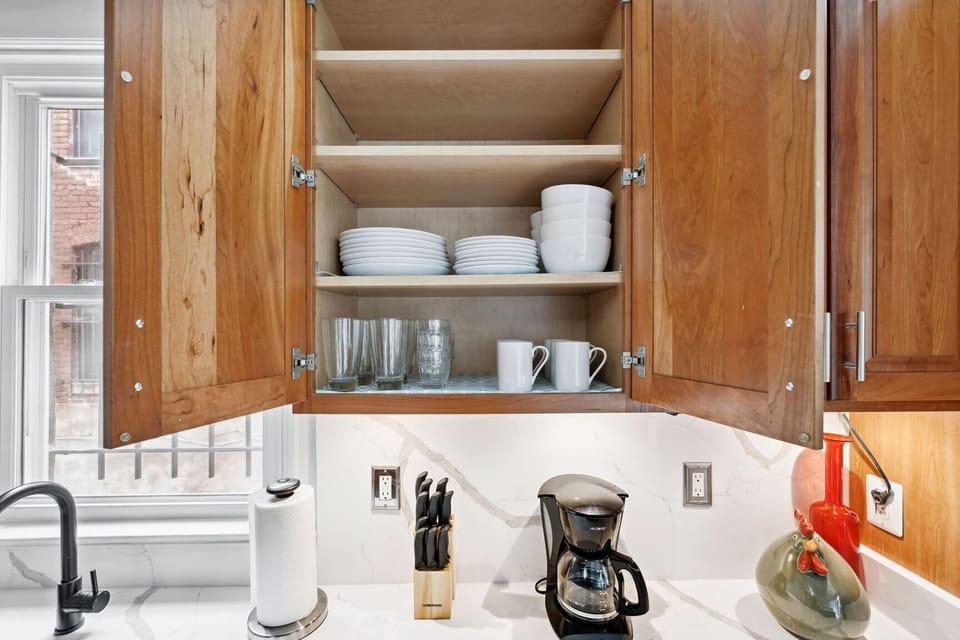 Kitchen essentials ready, coffee maker, dishes, and more at your fingertips.