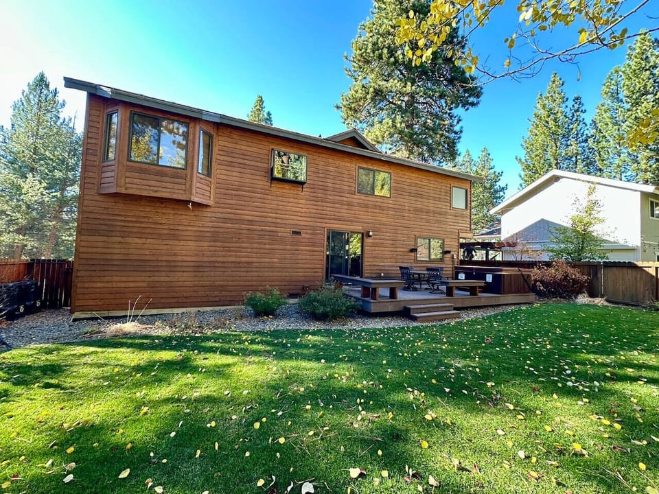 Large level backyard with deck and hot tub