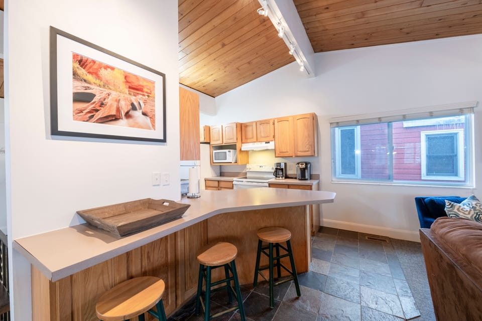 Counter w/ bar stools between kitchen and living room