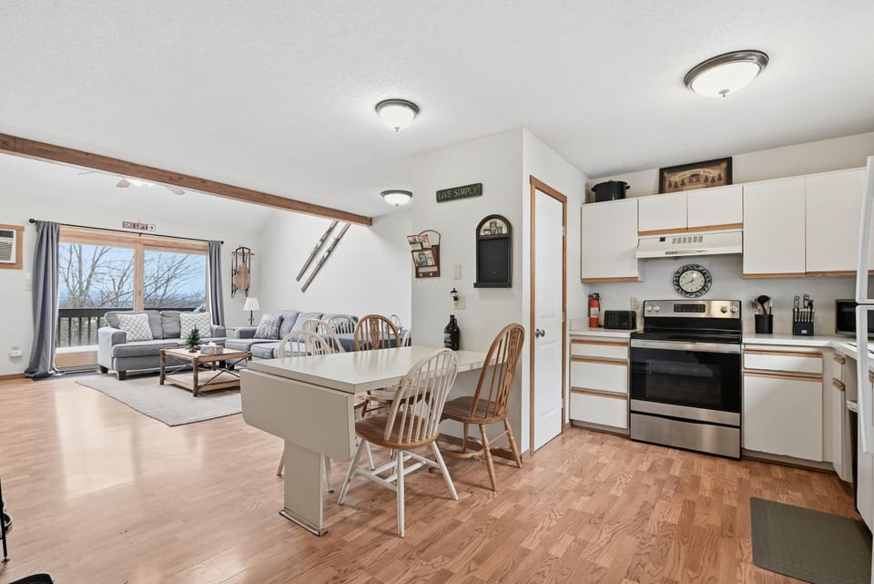 Kitchen (1/2 bath), living room.  2 dining tables. 