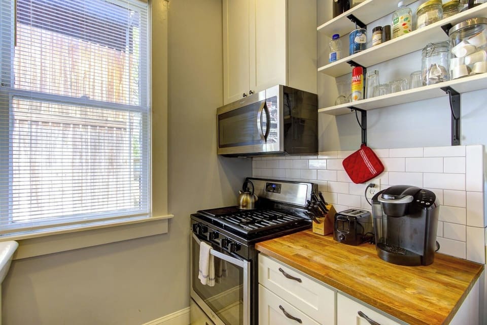 Gas stove and a microwave to cook up a quick meal.