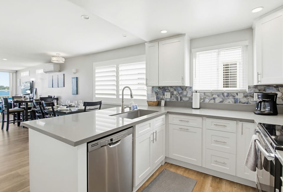 Fully equipped for meals at home. Includes stainless steel appliances: dishwasher, refrigerator, stove, and oven.