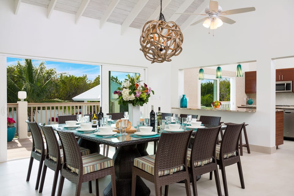 Dining table overlooks the pool and seats 12, breakfast bar seats 4