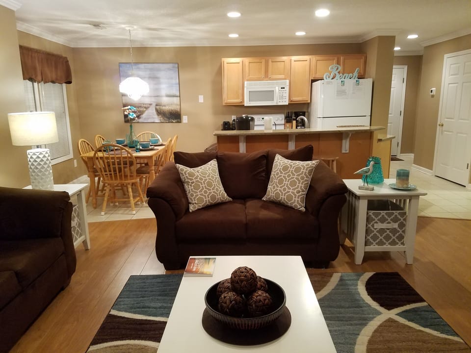 Sofa, loveseat, coffee and end tables, entertainment center and 50 inch T.V.