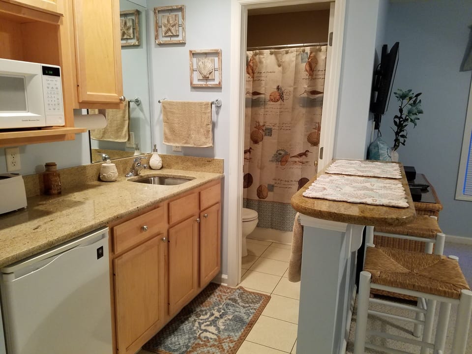 Kitchenette with granite countertops, and full-size bath in guest suite.