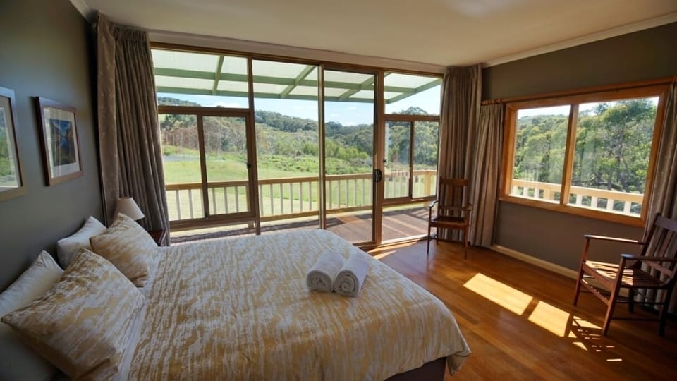 Master bedroom with king bed overlooking Tapanappa Creek and tennis court