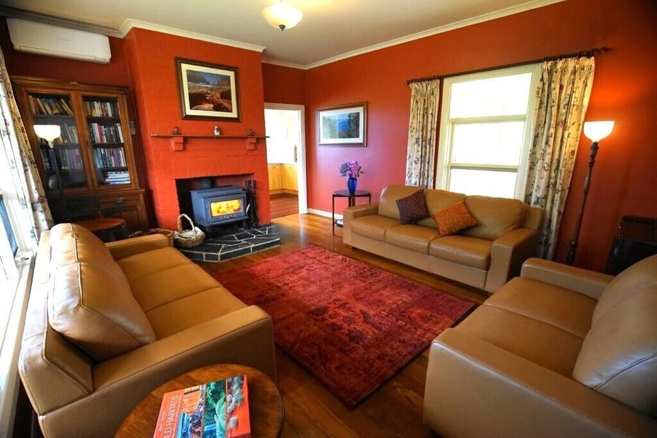 Cosy lounge with wood fire and beautiful art deco furnishings
