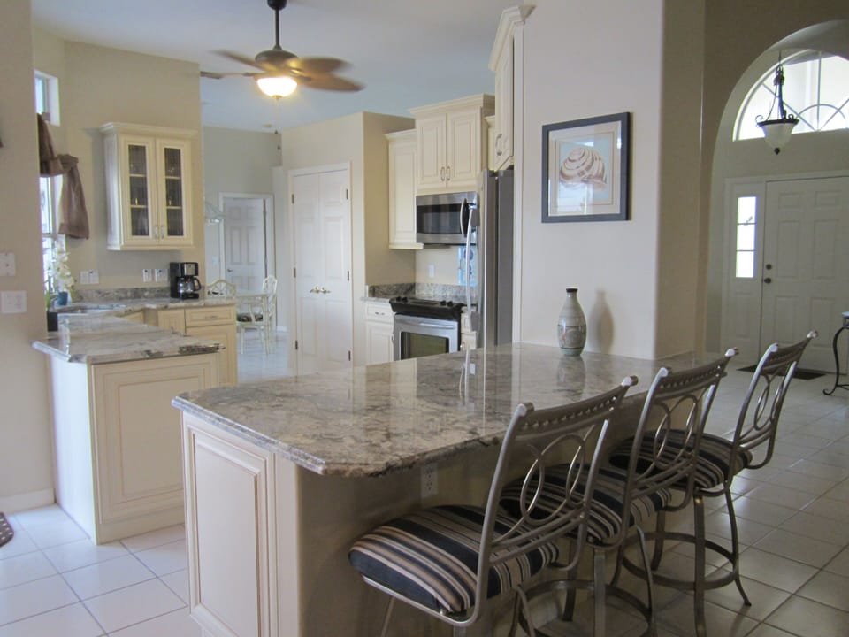 Renovated kitchen with breakfast bar, and new stainless steel appliances