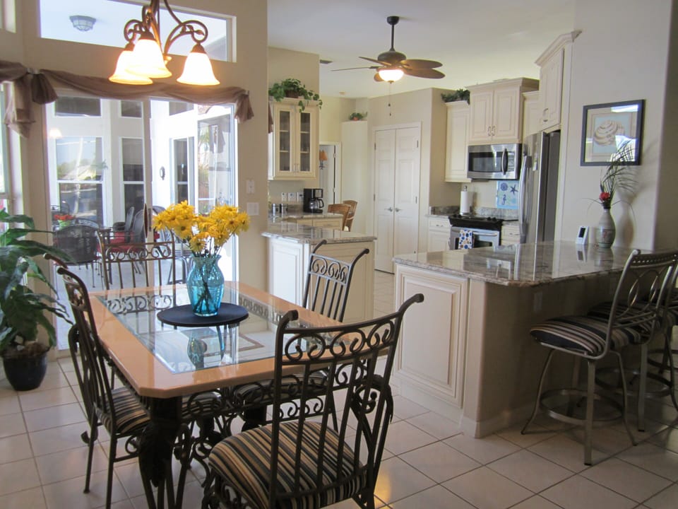 Breakfast area overlooking renovated kitchen with stainless steel appliances