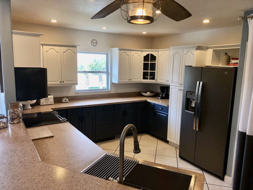 The kitchen is outfitted with GE appliances and fully stocked for any meal.