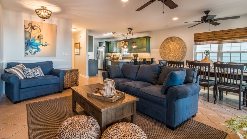 Spacious living room. Comfy couch, love seat,poufs for the kids. 