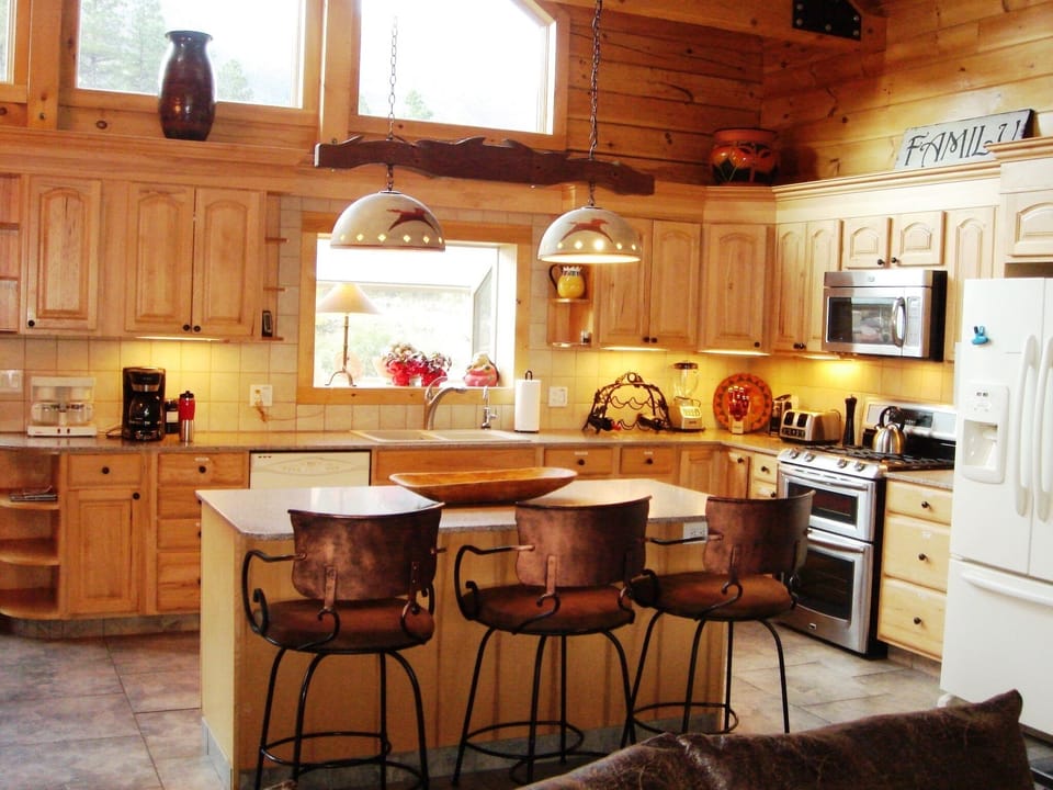 Gourmet kitchen has gas range with two ovens.