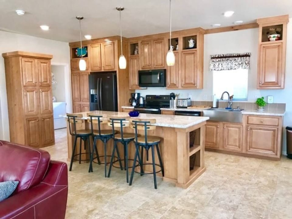 Kitchen with large island and black stainless appliance